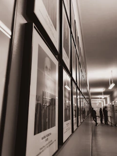 An elegant hallway featuring a series of black and white framed photographs from galleryframe.