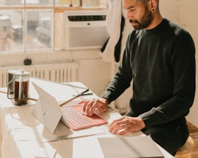 Close-up of a person using a tablet to send an invoice email.