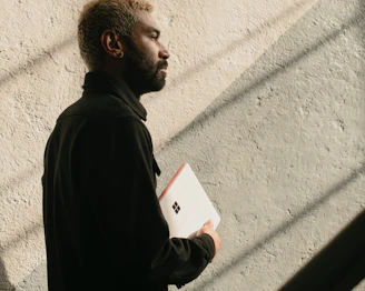 a man with a beard is holding a folder