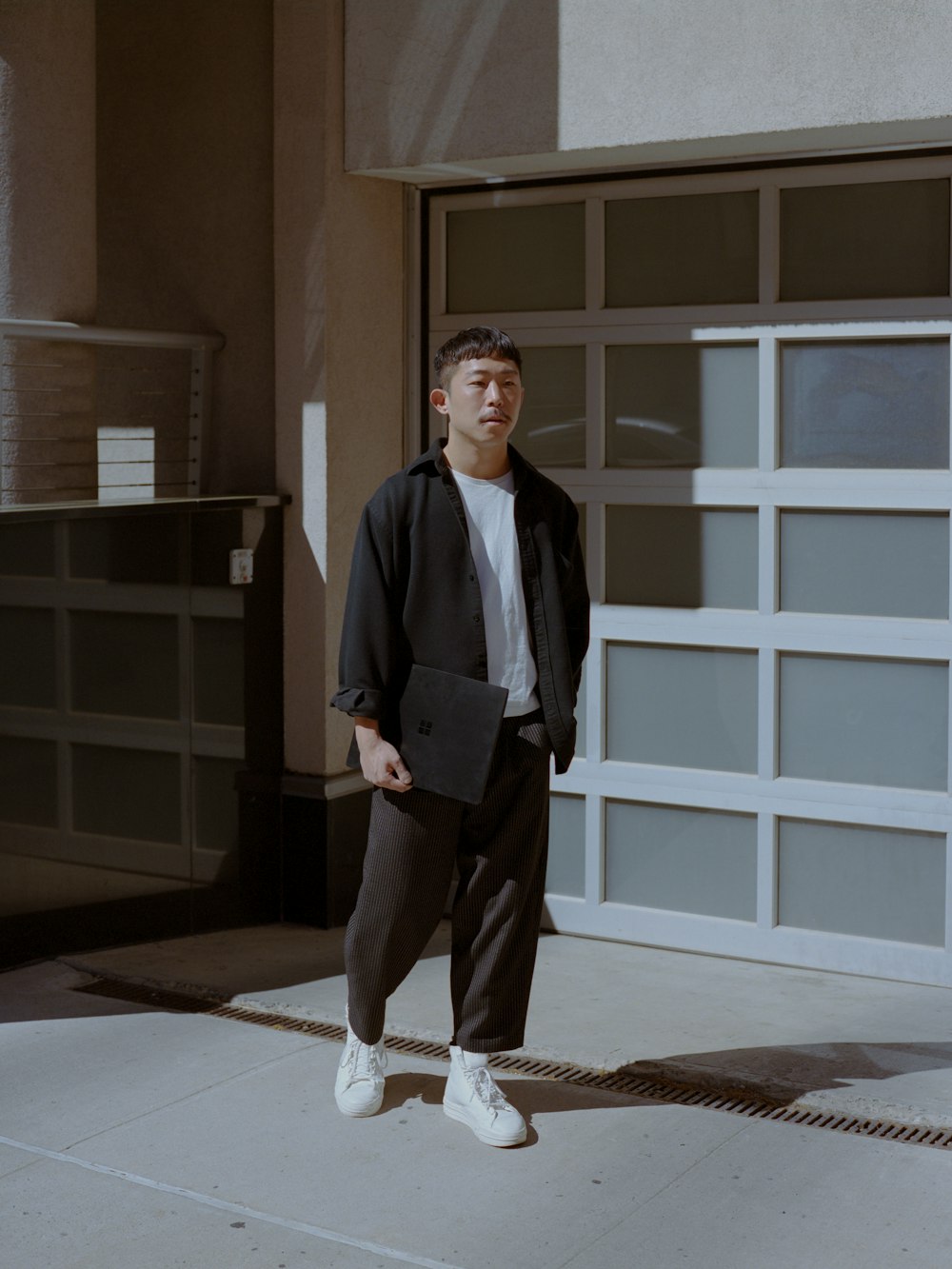 a man standing in front of a garage door