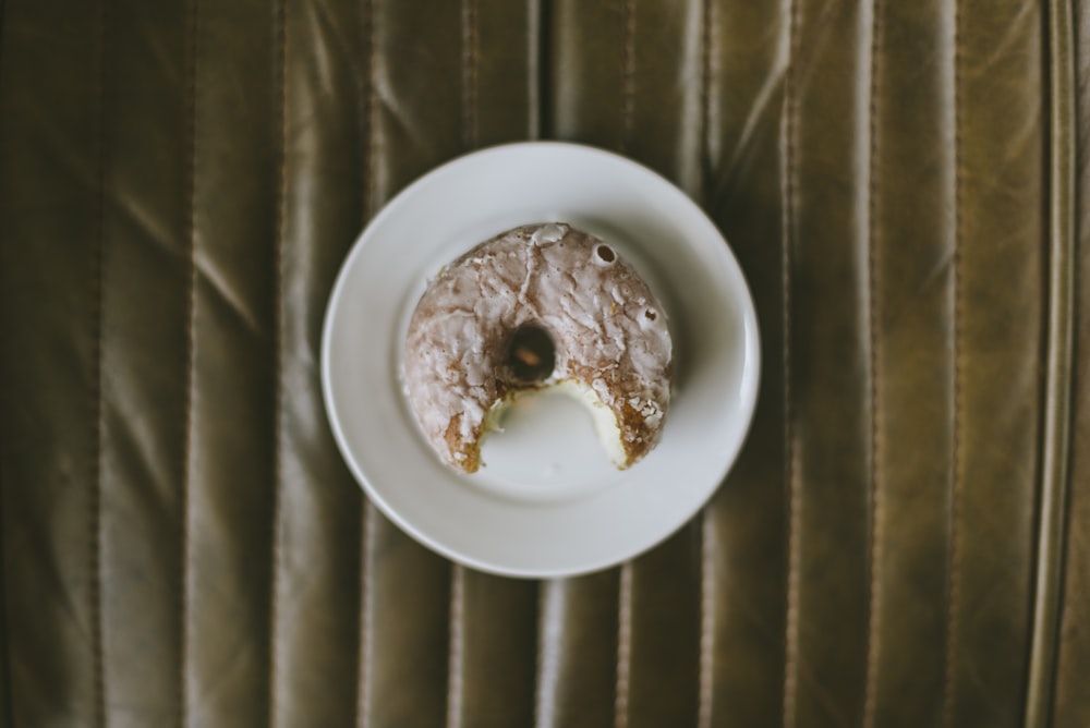 a donut with a bite taken out of it on a plate