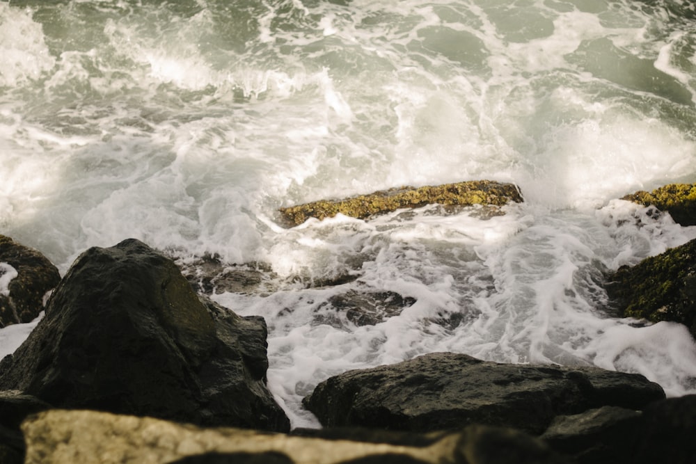 a rocky shore with waves crashing against the rocks