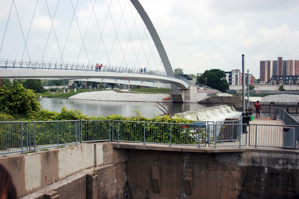 a bridge over a body of water with a bridge in the background