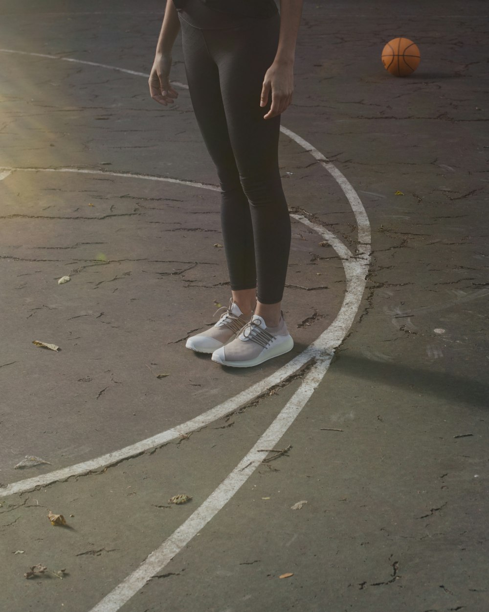 a person standing on a basketball court with a ball