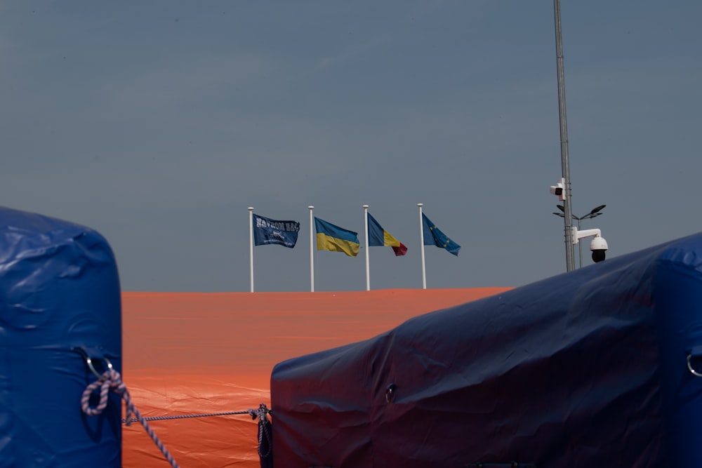 a group of flags that are on a pole