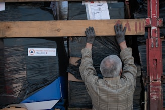 a man is working on a piece of wood