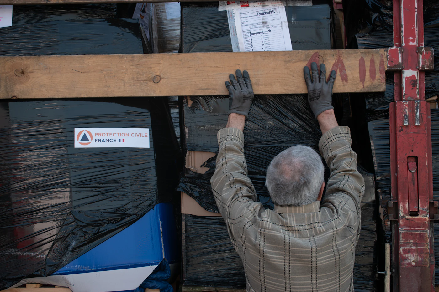 A volunteer securing a pallet of aid
