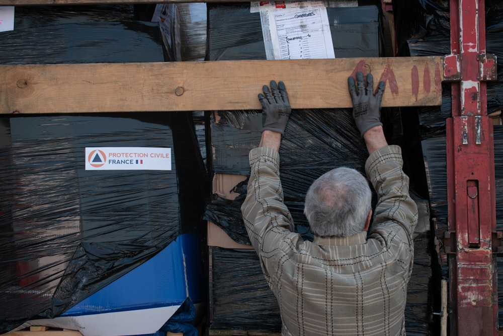 a man is working on a piece of wood