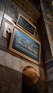 a blue sign hanging on the side of a building