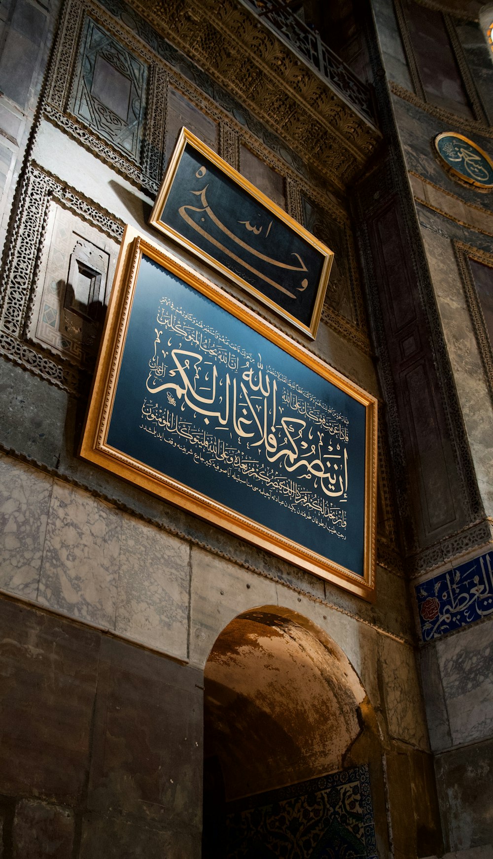 a blue sign hanging on the side of a building