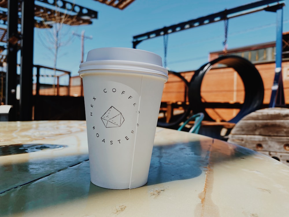 a cup of coffee sitting on top of a table