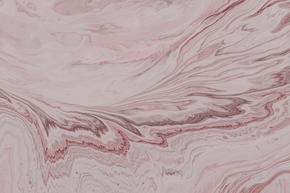a close up of a pink and black marble