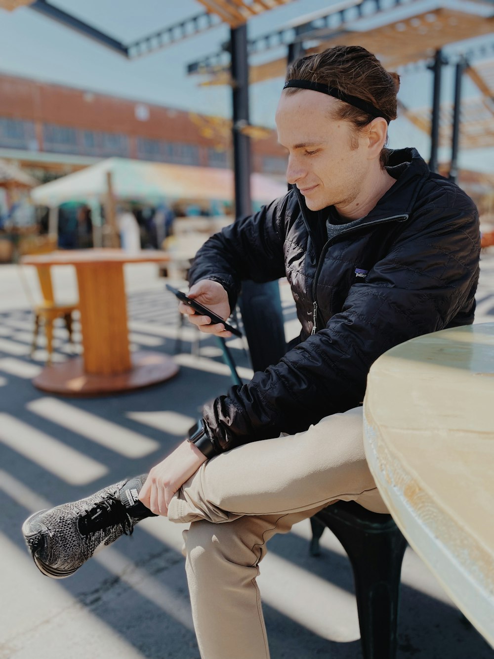 a man sitting on a bench looking at his cell phone