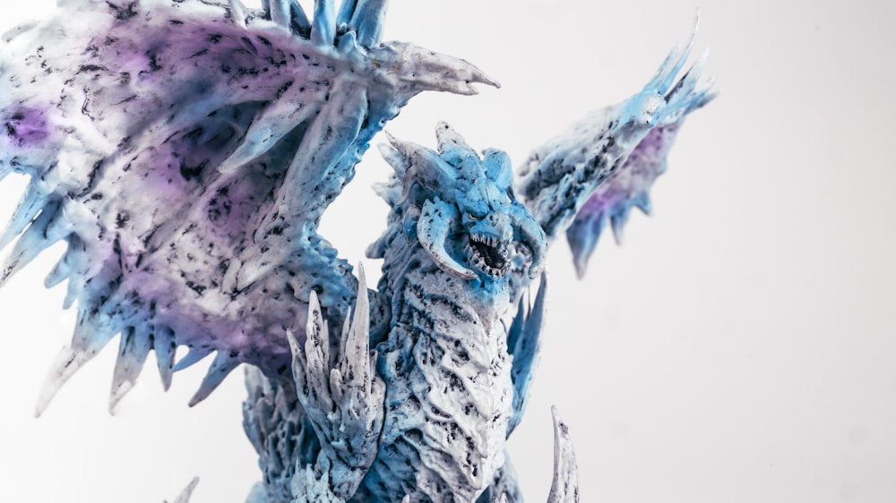 a close up of a blue and white dragon statue