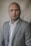a man in a gray suit and white shirt