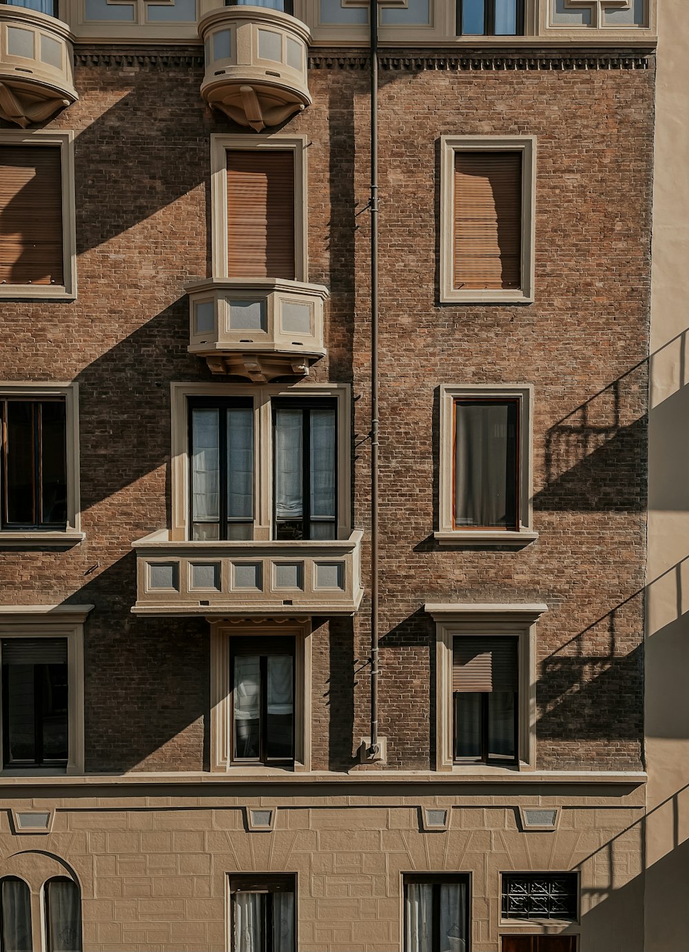 a tall brick building with many windows and balconies