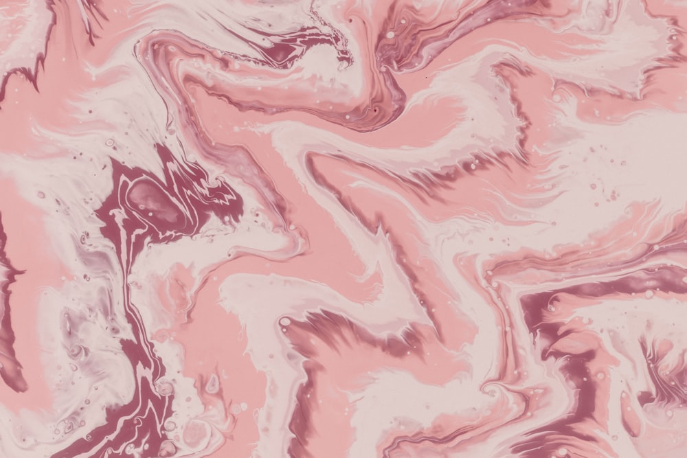 a pink and white marble pattern with a pink background