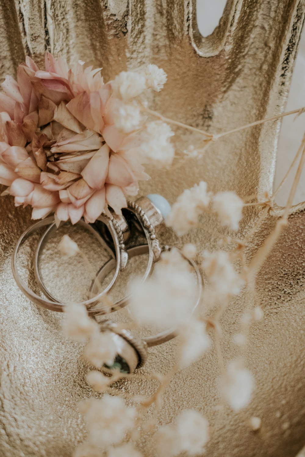 a bunch of wedding rings sitting on top of a table