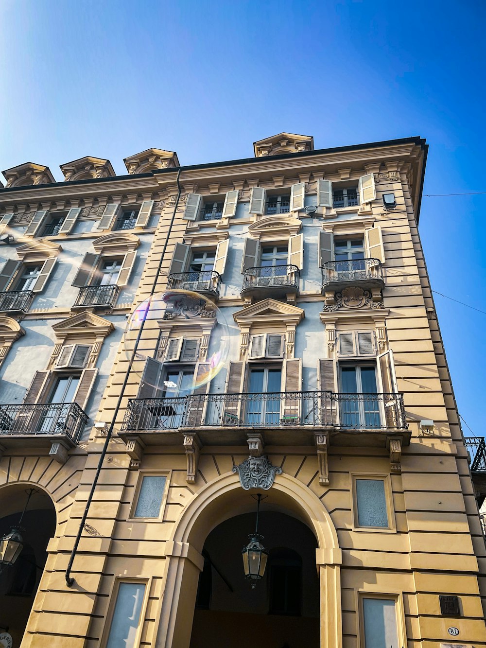 a tall building with lots of windows and balconies