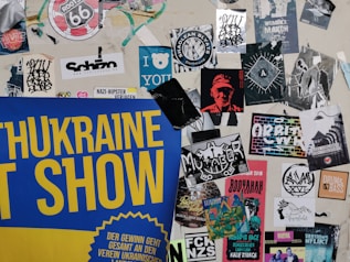 a wall covered in stickers and posters
