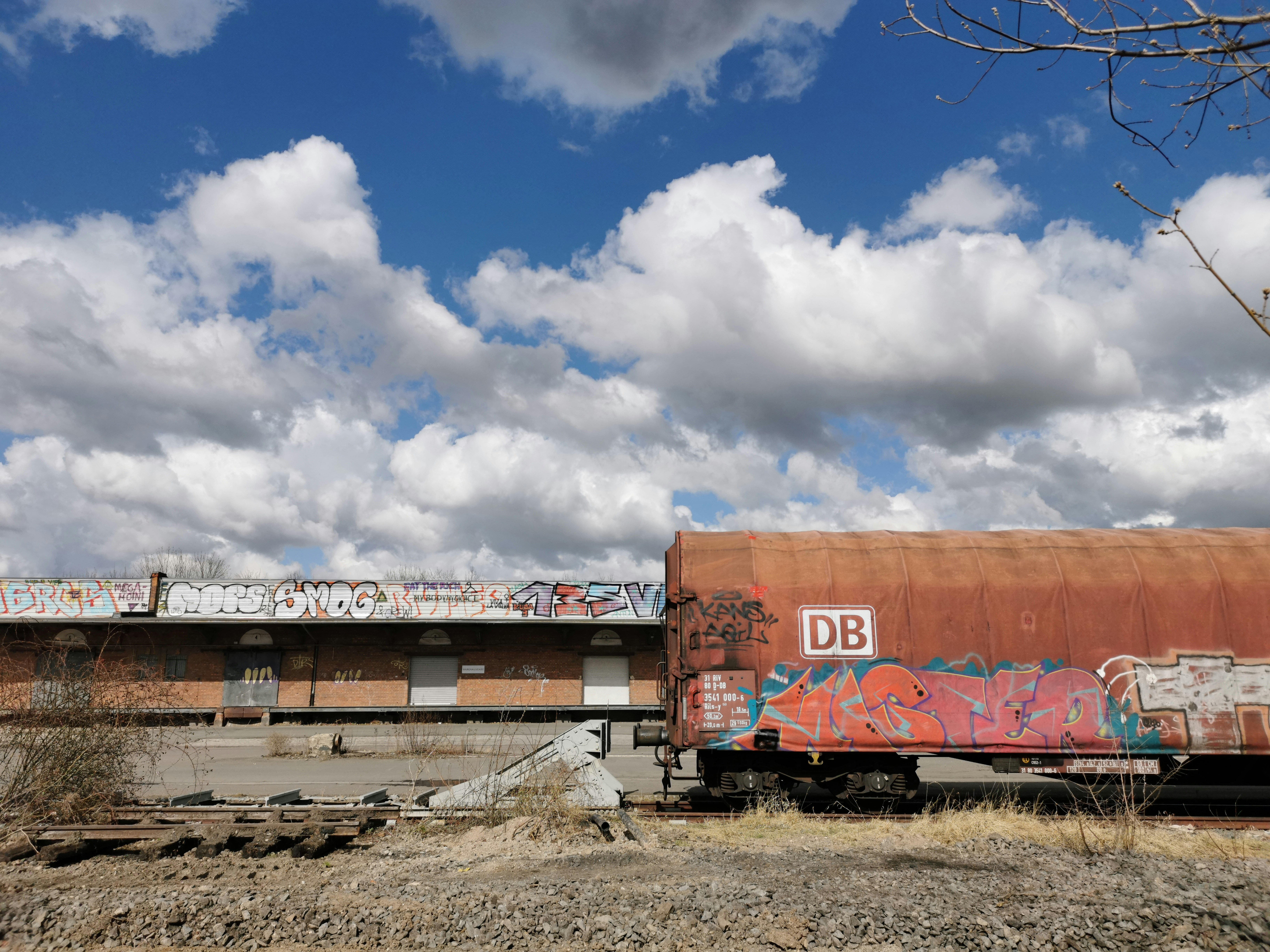 a rusted train car with graffiti on the side of it