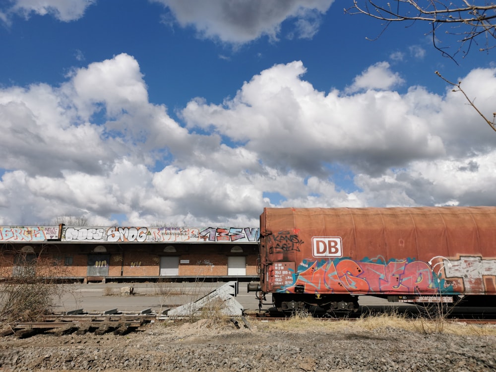 a rusted train car with graffiti on the side of it