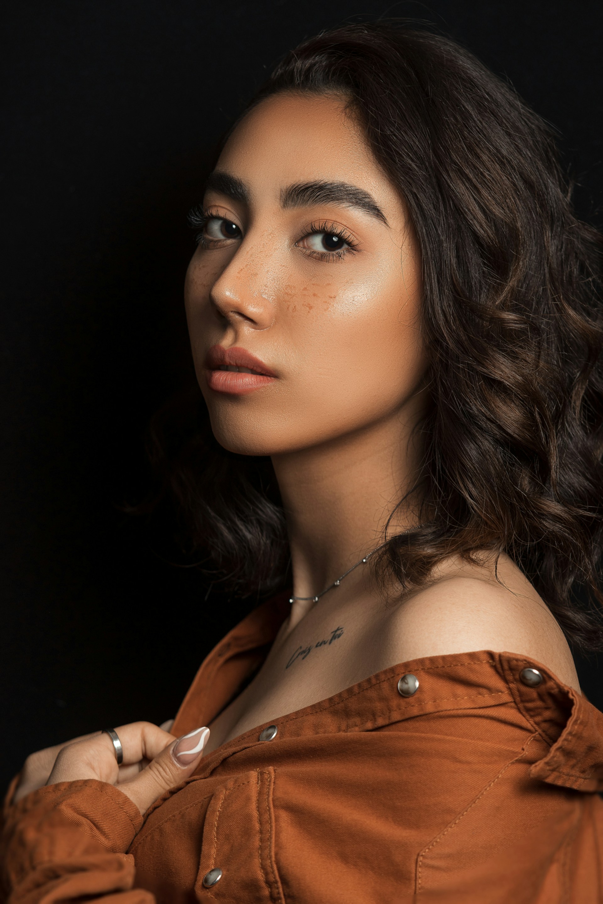 a woman in a brown shirt posing for a picture