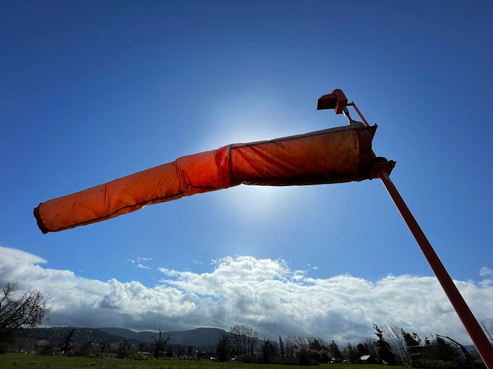 a large orange object with a flag on top of it