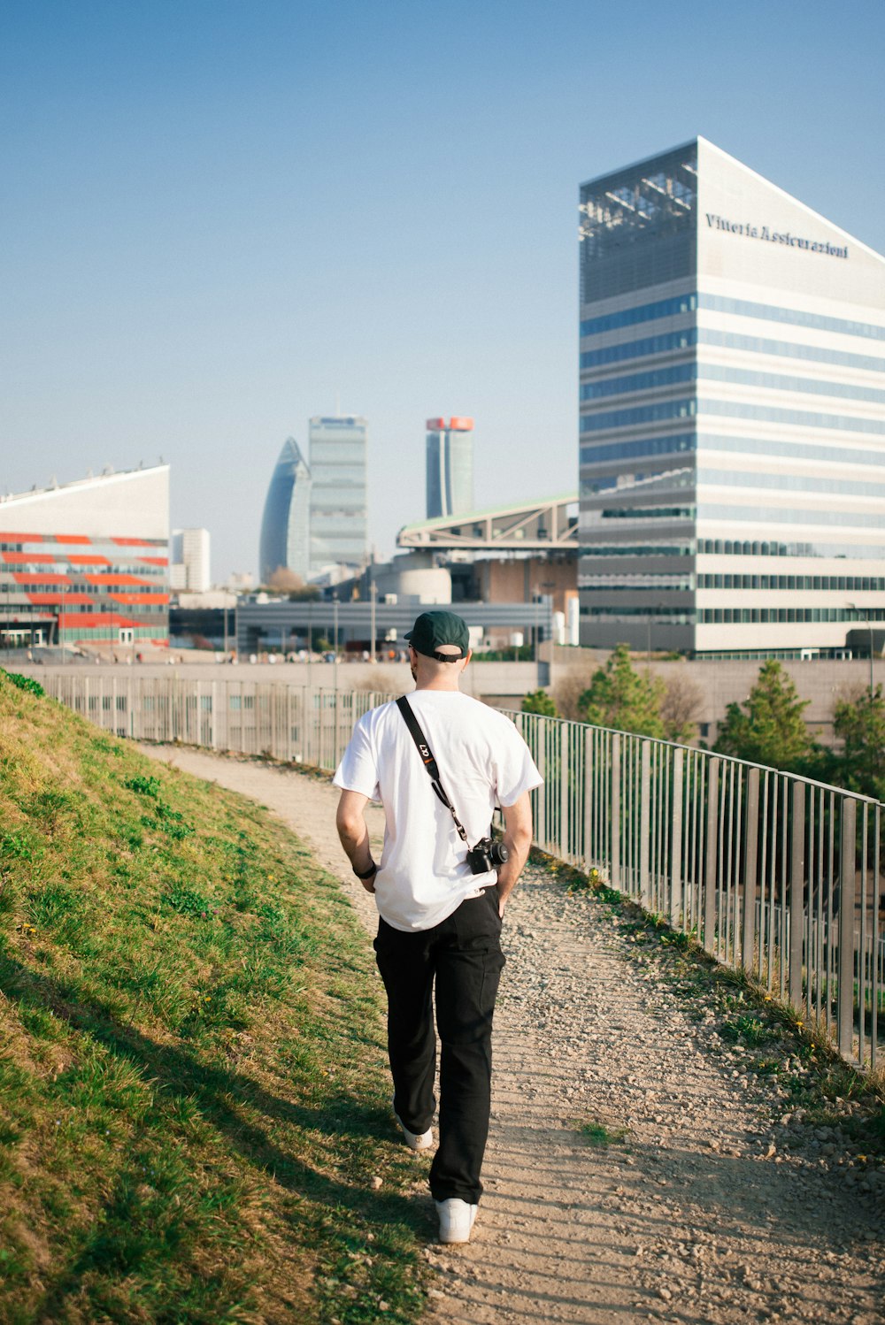 a man walking down a path in a city