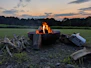 a fire pit sitting in the middle of a field