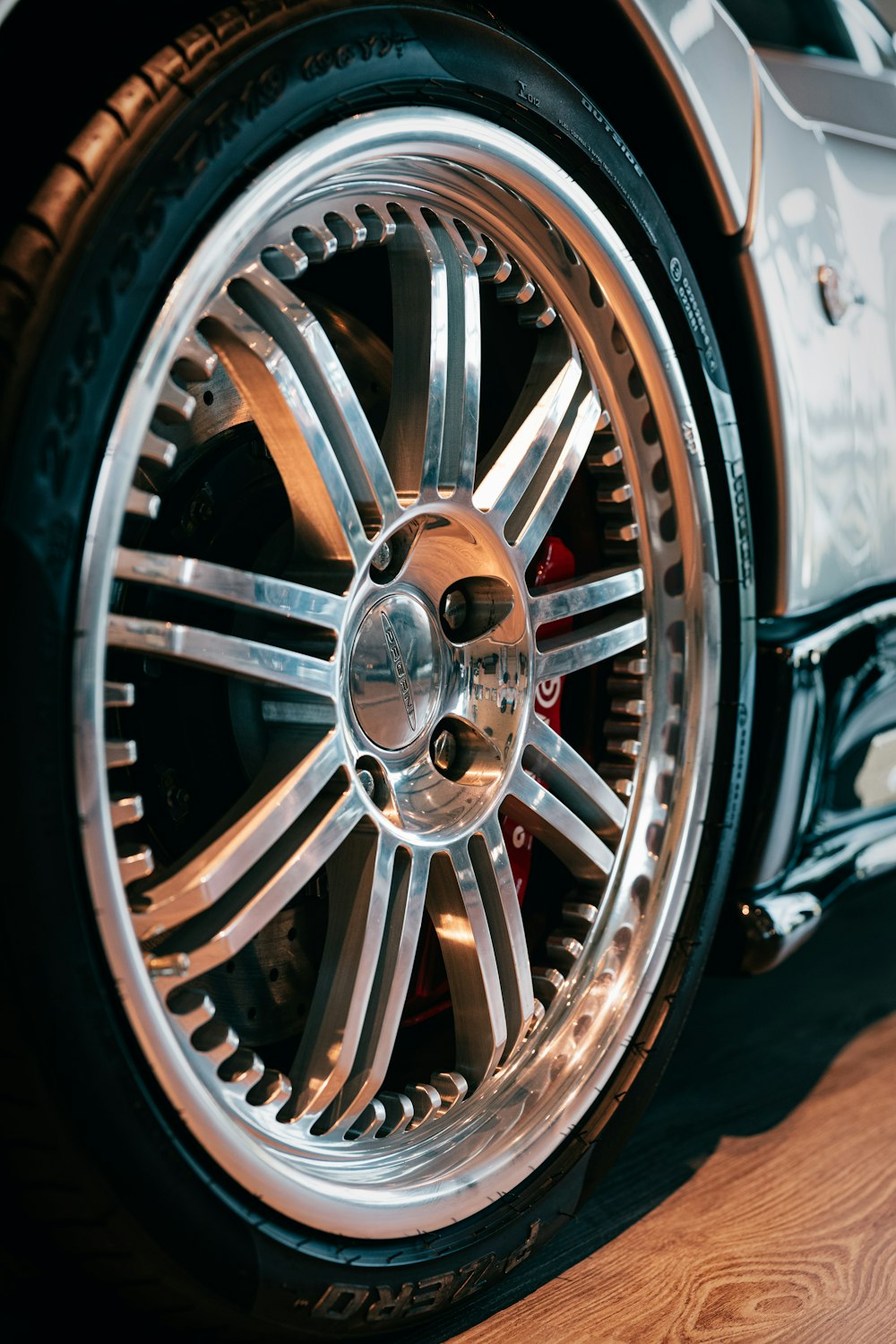 a close up of a car tire on a wooden floor