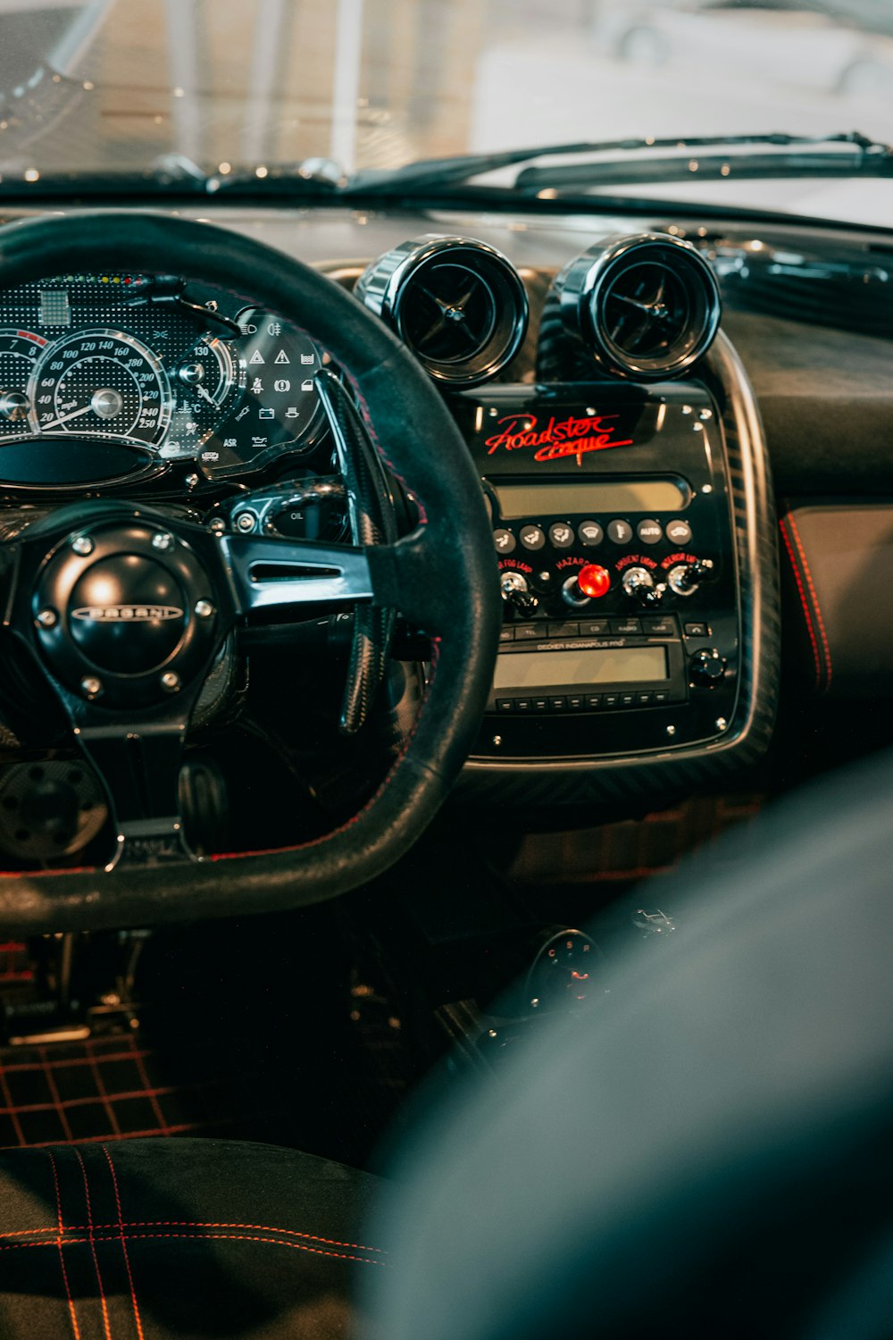 a dashboard of a car with a steering wheel