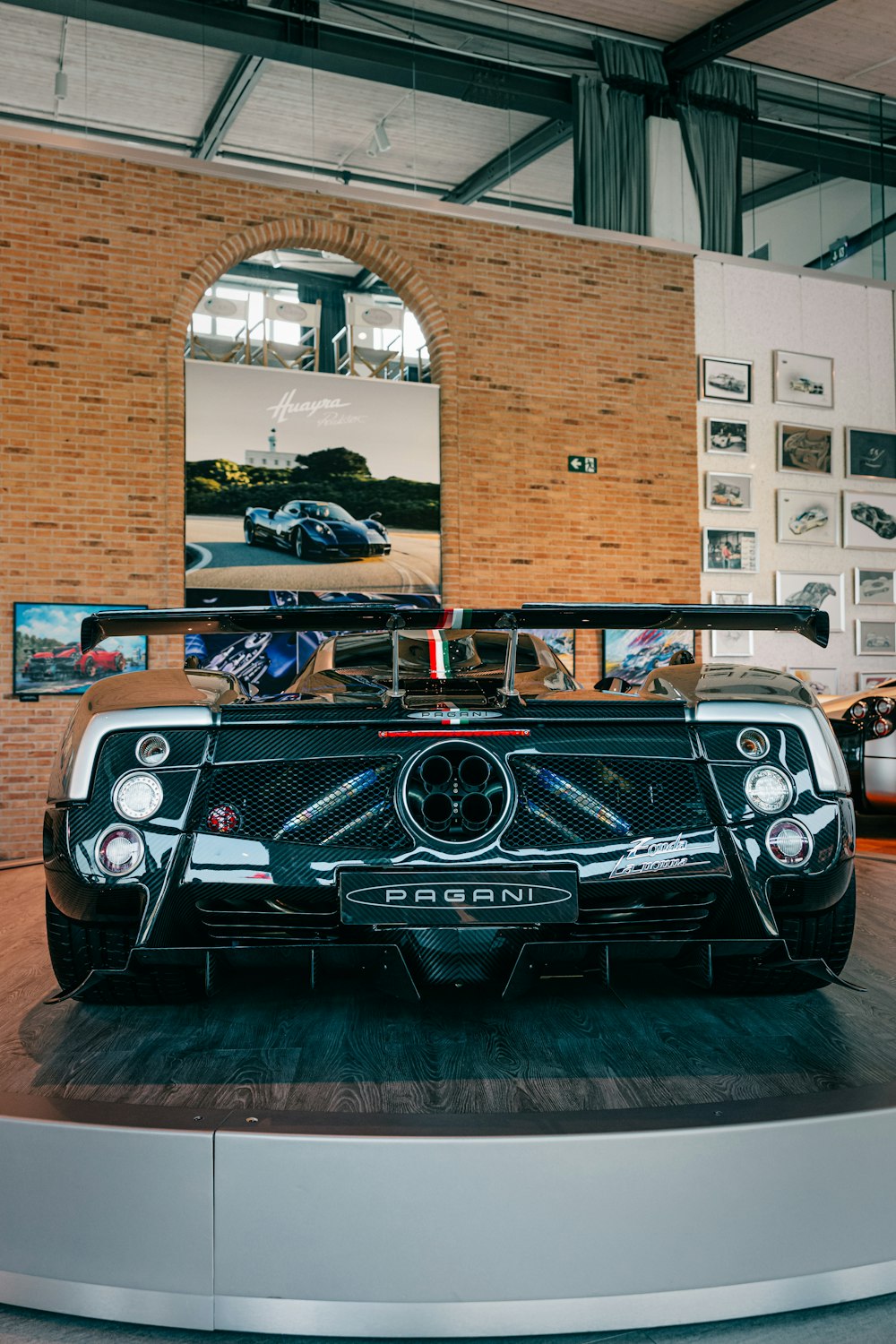 a black and white car on display in a building