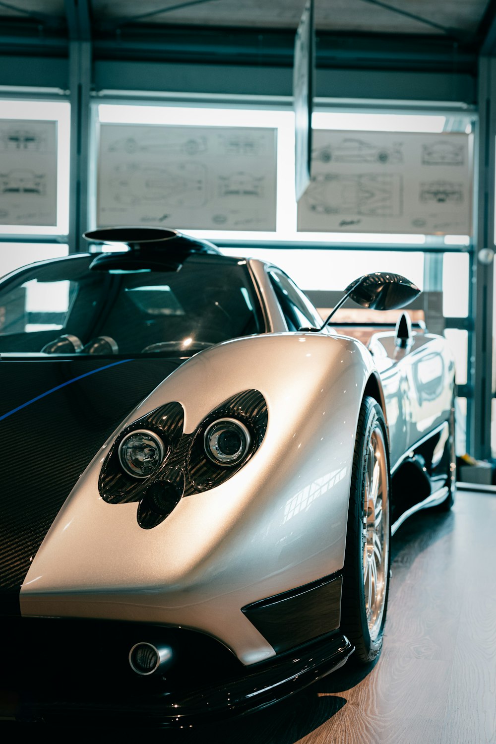 a white and black sports car parked in a garage