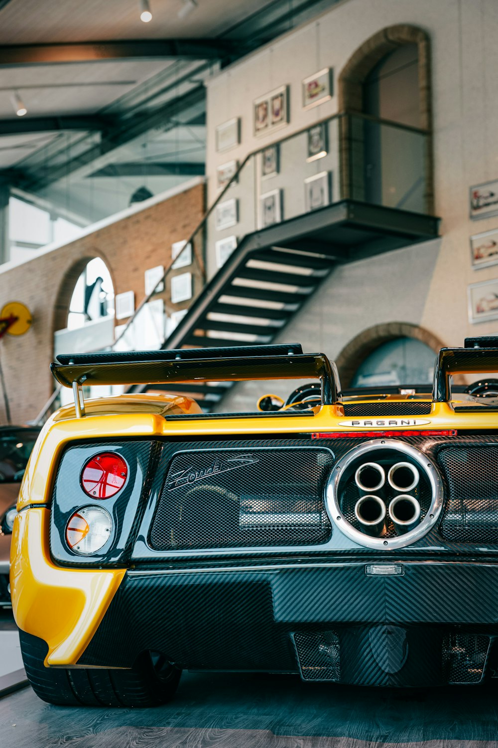 a yellow sports car parked in a garage