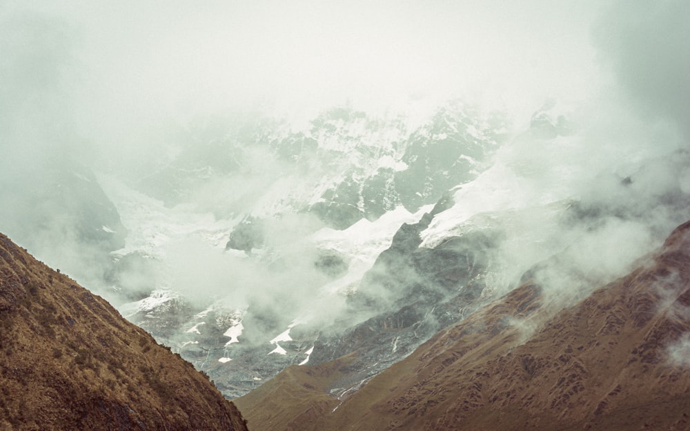 a man riding a horse on top of a mountain