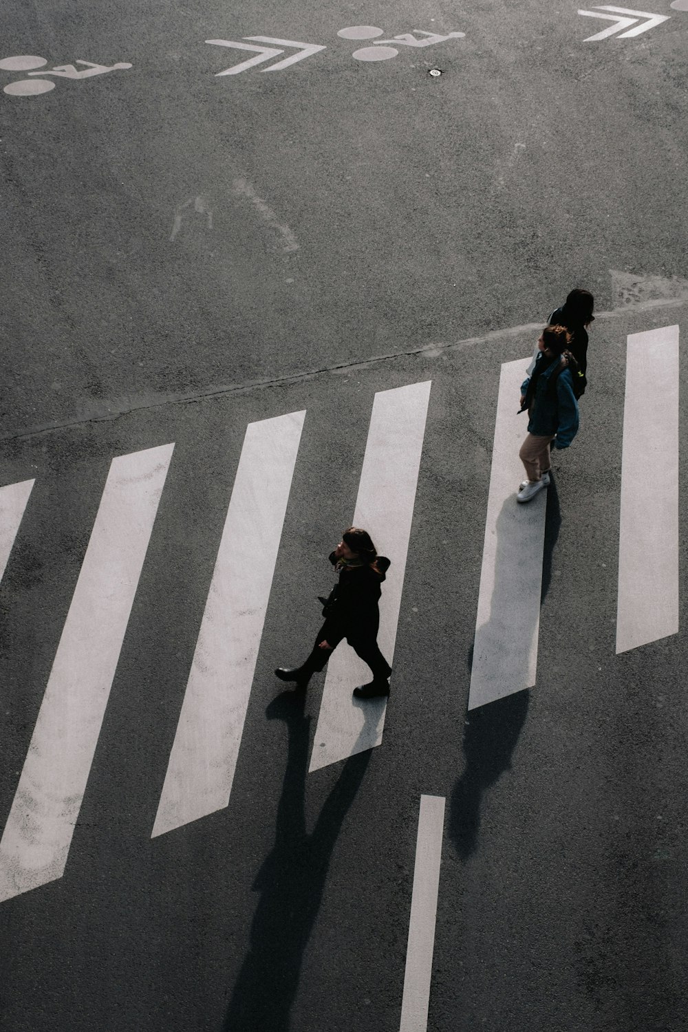 a couple of people walking across a street