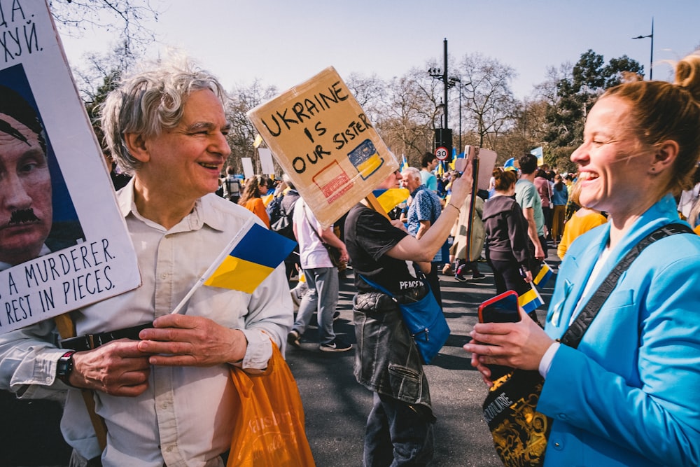 a group of people holding signs in a protest