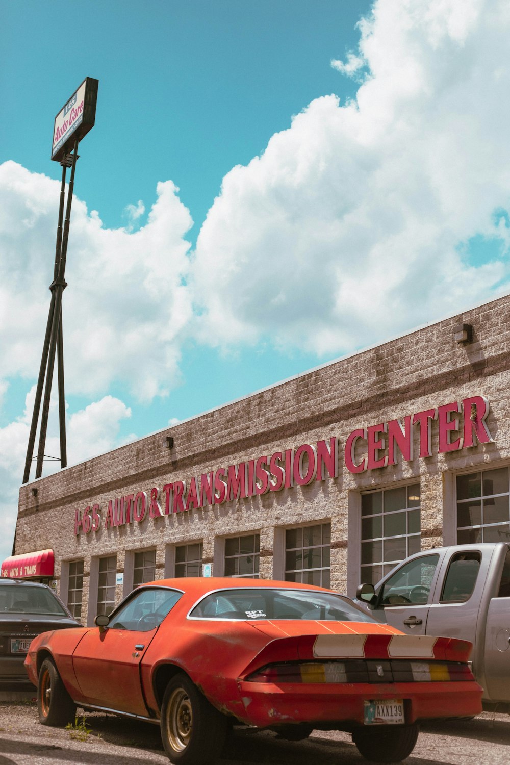 a red car parked in front of a building