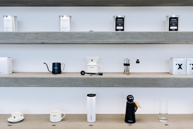 Small appliance parts like vacuum cleaner filters and coffee machine accessories on a shelf