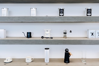 Small appliance parts like vacuum cleaner filters and coffee machine accessories on a shelf