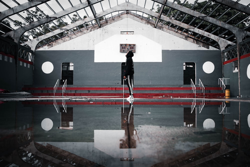 a person standing in front of a basketball hoop