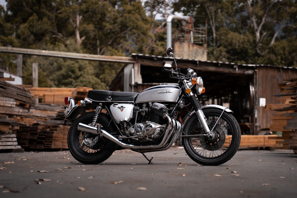 a motorcycle parked next to a pile of wood