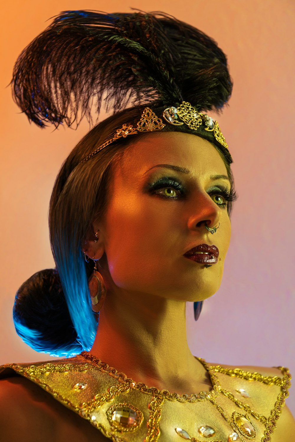 a woman in a gold dress with feathers on her head