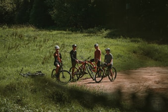 a group of people standing next to each other on bikes