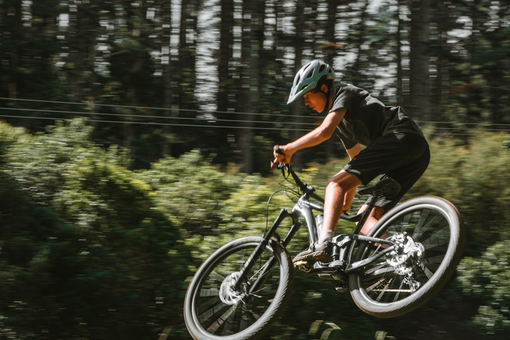 a man riding a bike through the air