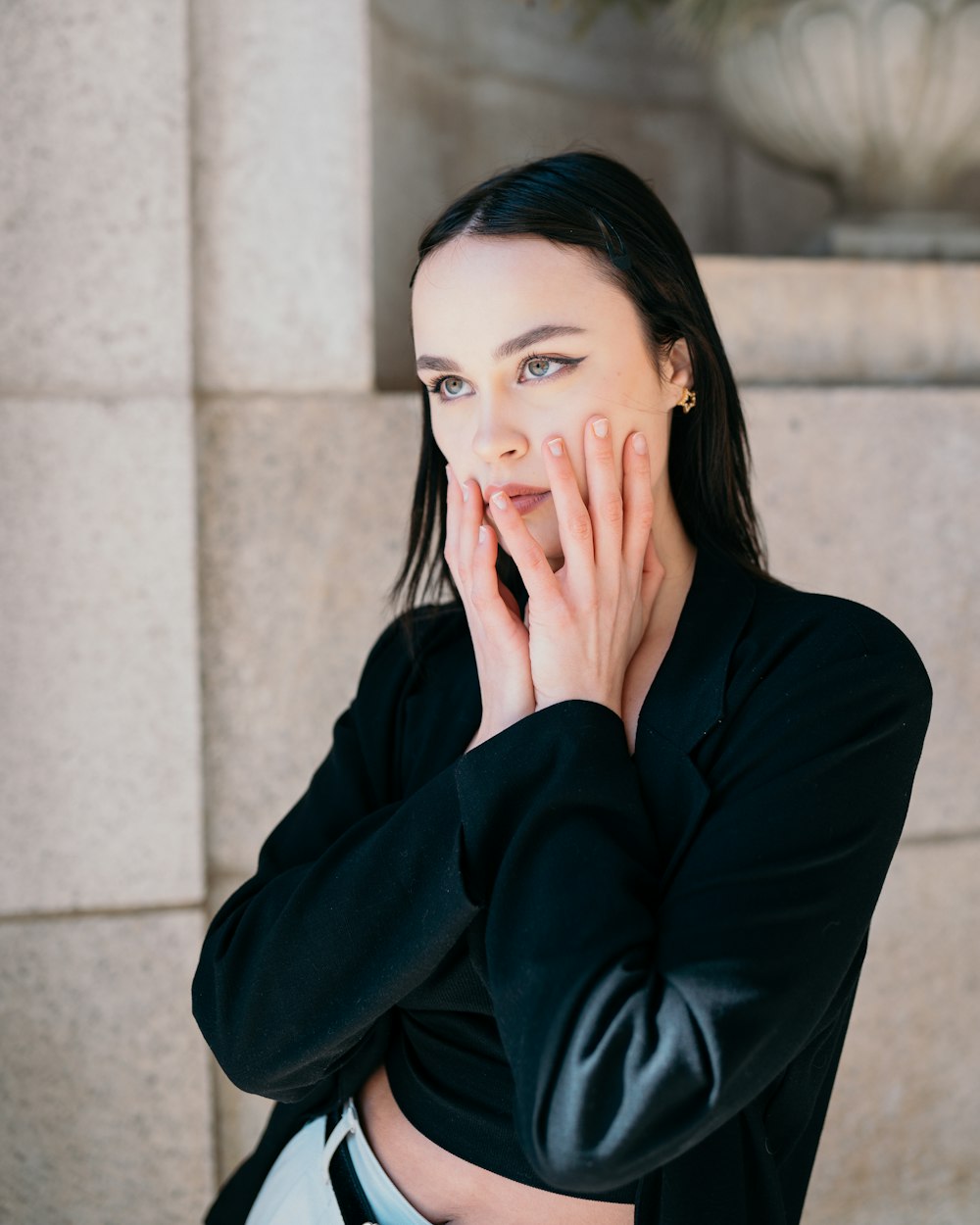 a woman with her hands on her face