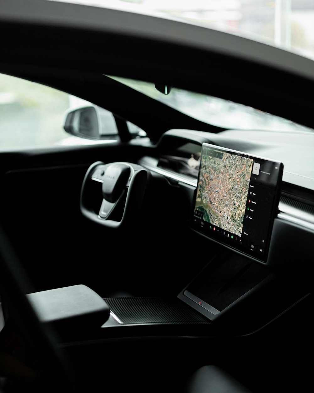 a car dashboard with a monitor and a laptop