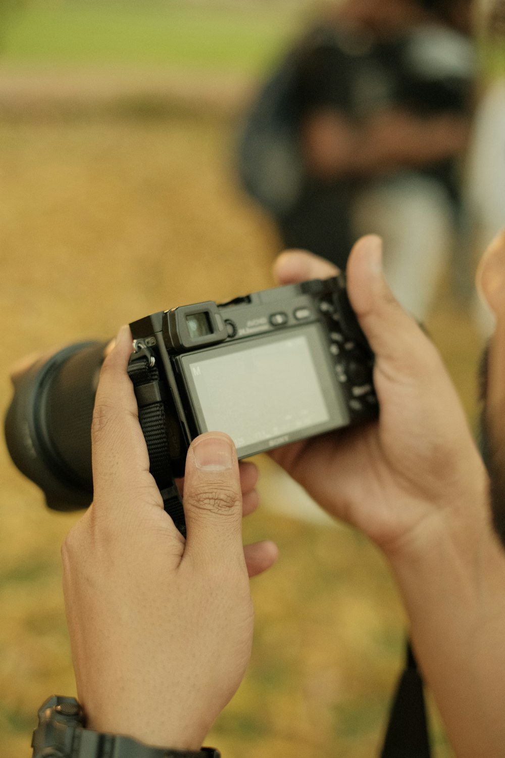 a man holding a camera up to take a picture