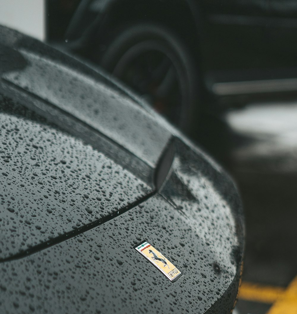 a close up of a black car parked in a parking lot